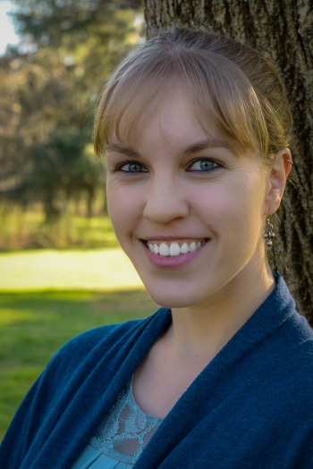 Kristel Roper, LMFT - smiling, white woman with blonde hair in a blue sweater standing outside