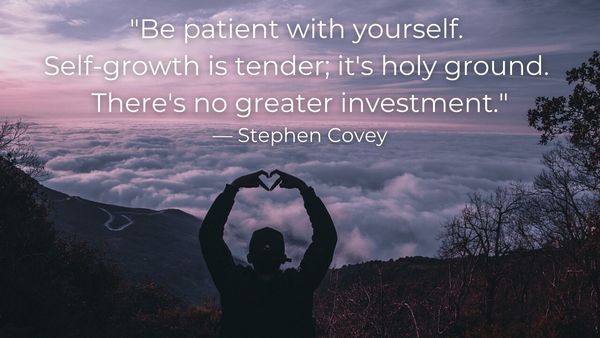 Silhouette of a man making a heart with his fingers in front of a valley full of clouds with quote: 104.	“Be patient with yourself. Self-growth is tender; it’s holy ground. There’s no greater investment.”— Stephen Covey