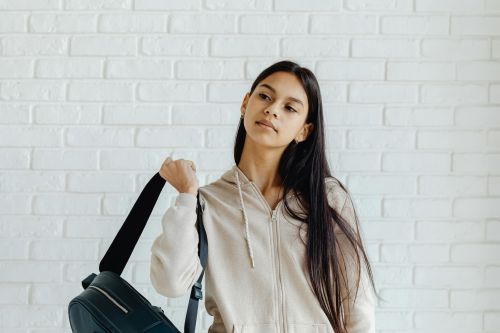 Dauntless Counseling Anxiety & OCD Therapy for Kids & Teens - Image of a teen holding her backpack